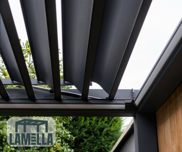 Nahaufnahme einer modernen Pergola im Freien mit individuell gestalteten, verstellbaren Lamellendachpaneelen, teilweise geöffnet. Im Hintergrund ist üppiges grünes Laub zu sehen, das die natürliche Schönheit der Umgebung unterstreicht. Eine Glaswand verleiht eine elegante Note. In der unteren linken Ecke ist ein Logo mit dem Namen „Lamellendach nach Maß (Preis auf Anfrage)“ zu sehen.